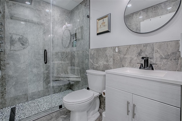 17009 SE 96th Chapelwood Cir, The Villages, FL 32162 - full bath featuring toilet, vanity, tile walls, a shower stall, and a wainscoted wall