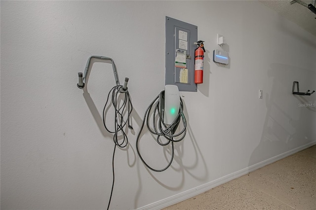 17009 SE 96th Chapelwood Cir, The Villages, FL 32162 - garage view of baseboards and a fire extinguisher