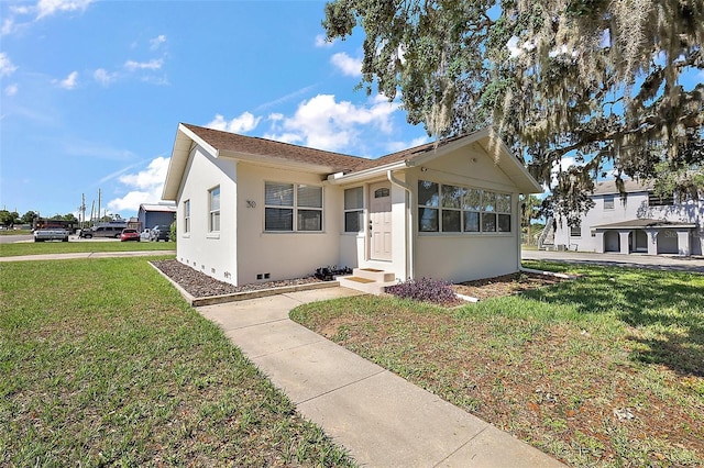 30 E Key Ave, Eustis, FL 32726 - view of front of home with a front lawn, stucco siding, and entry steps