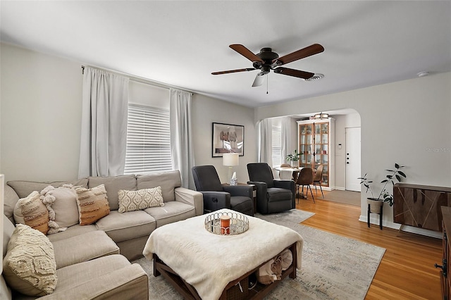 30 E Key Ave, Eustis, FL 32726 - living area featuring ceiling fan, arched walkways, and light wood-type flooring