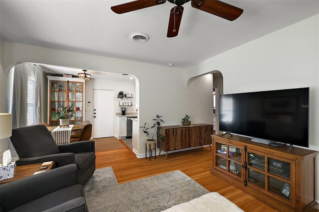 30 E Key Ave, Eustis, FL 32726 - living area featuring arched walkways, a ceiling fan, and wood finished floors