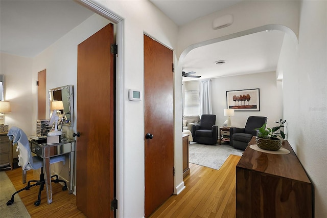 30 E Key Ave, Eustis, FL 32726 - hall featuring light wood finished floors, a desk, and arched walkways