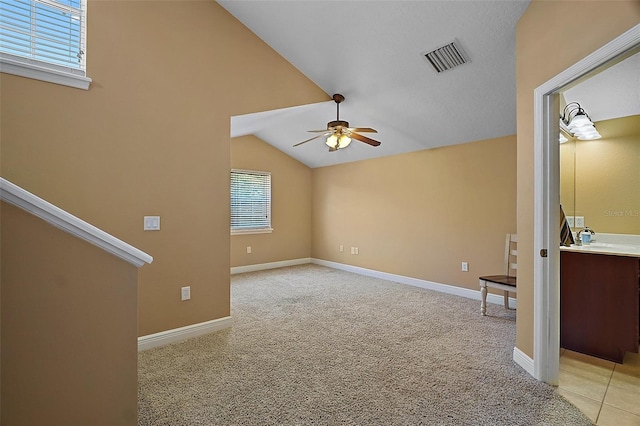 397 Anderson Dr, Tavares, FL 32778 - unfurnished living room featuring a ceiling fan, lofted ceiling, light colored carpet, and baseboards