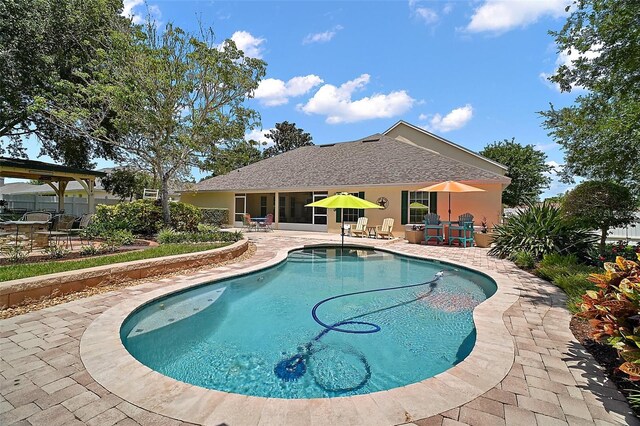 397 Anderson Dr, Tavares, FL 32778 - swimming pool with a patio area and a sunroom