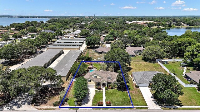 397 Anderson Dr, Tavares, FL 32778 - aerial perspective of suburban area with property parcel outlined and a nearby body of water