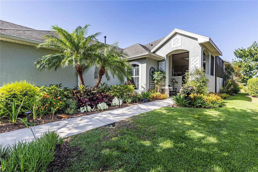 7873 Crosswinds Way, Mount Dora, FL 32757 - view of front of property featuring stucco siding and a front yard