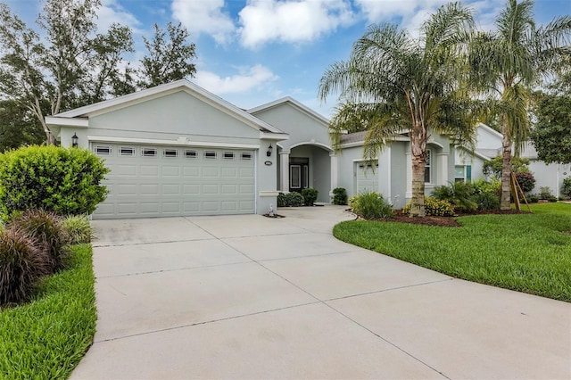 4581 Shenandoah River Trl, Leesburg, FL 34748 - single story home with driveway, stucco siding, an attached garage, and a front yard