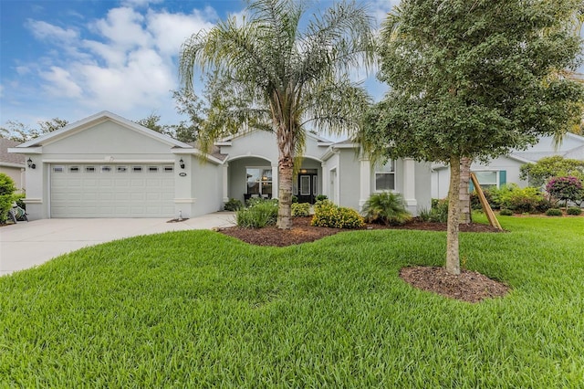 4581 Shenandoah River Trl, Leesburg, FL 34748 - view of front facade featuring a garage, driveway, stucco siding, and a front lawn