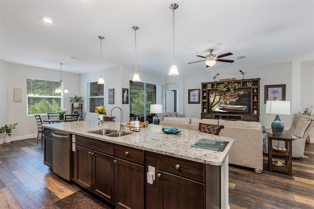 4581 Shenandoah River Trl, Leesburg, FL 34748 - kitchen featuring a sink, dark wood-type flooring, open floor plan, dark brown cabinetry, and healthy amount of natural light