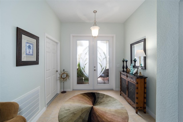 foyer featuring light tile patterned floors, french doors, and baseboards
