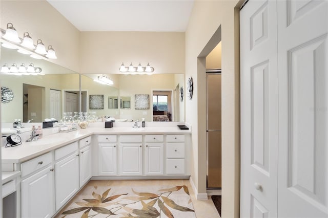 bathroom featuring double vanity, a shower stall, and tile patterned floors