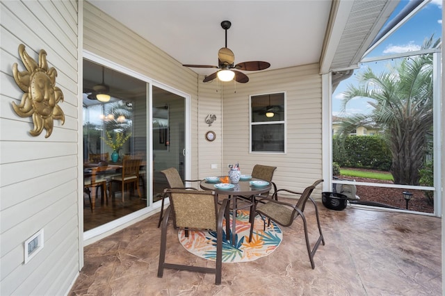 sunroom featuring a ceiling fan and outdoor dining area