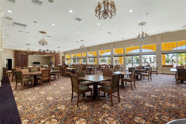 carpeted dining space featuring a chandelier, ornamental molding, and recessed lighting