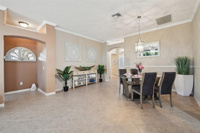 17108 SE 76th Creekside Cir, The Villages, FL 32162 - dining space featuring arched walkways, crown molding, light tile patterned floors, and baseboards