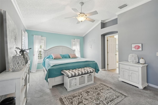 17108 SE 76th Creekside Cir, The Villages, FL 32162 - bedroom featuring a textured ceiling, vaulted ceiling, crown molding, light carpet, and a ceiling fan