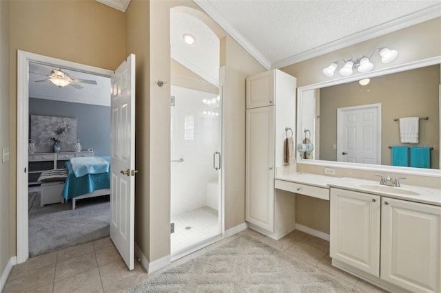 17108 SE 76th Creekside Cir, The Villages, FL 32162 - full bathroom featuring crown molding, connected bathroom, tile patterned floors, a stall shower, and vanity