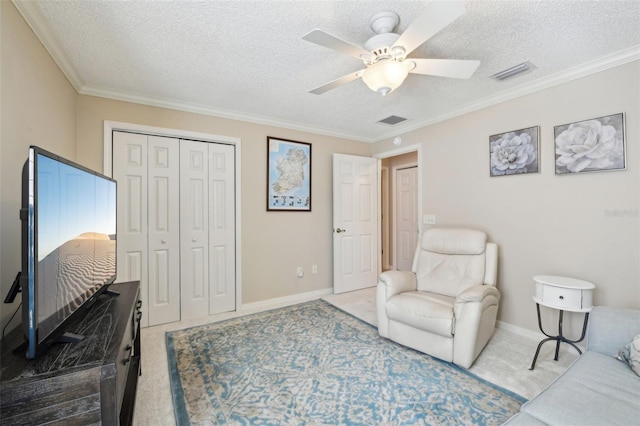 17108 SE 76th Creekside Cir, The Villages, FL 32162 - living area with carpet floors, ceiling fan, a textured ceiling, baseboards, and crown molding