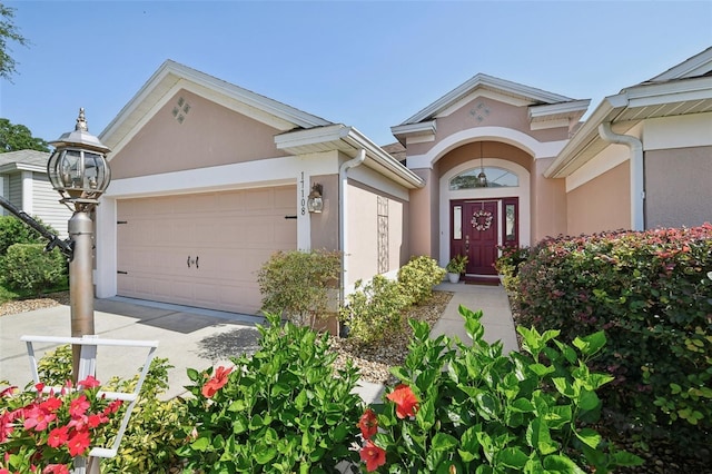 17108 SE 76th Creekside Cir, The Villages, FL 32162 - property entrance featuring stucco siding, a garage, and concrete driveway