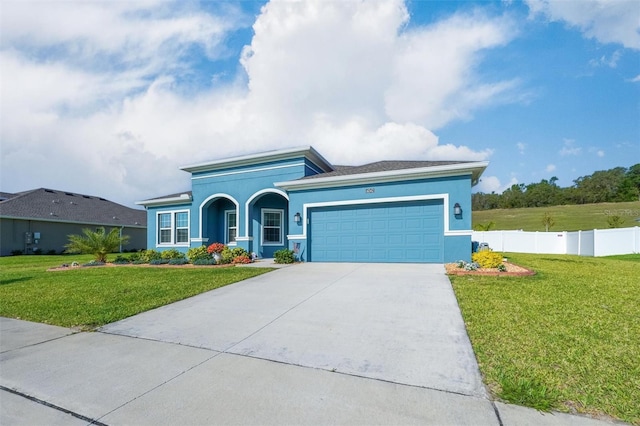 ranch-style house featuring an attached garage, concrete driveway, and stucco siding