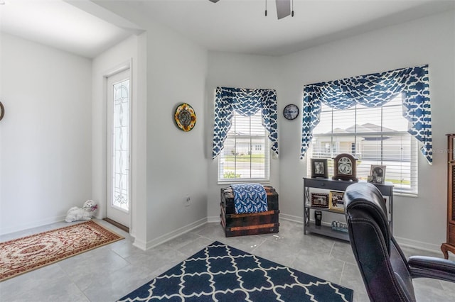 tiled office featuring plenty of natural light, ceiling fan, and baseboards