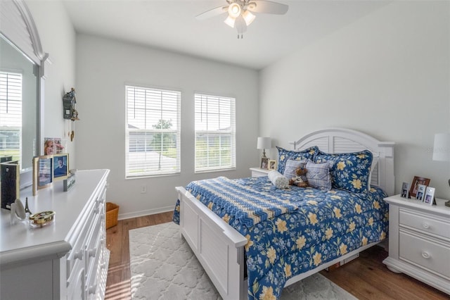 bedroom featuring light wood-style floors, ceiling fan, and baseboards