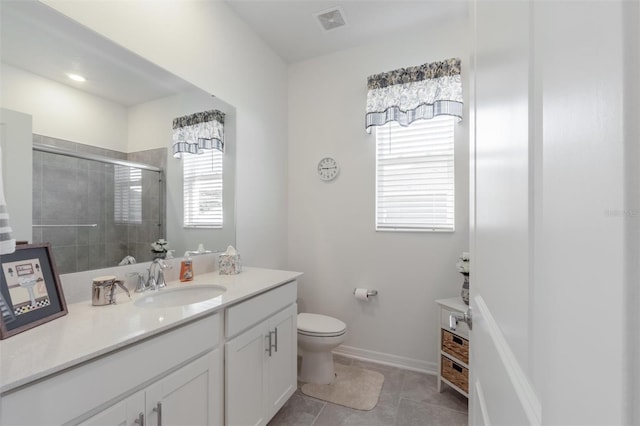 full bathroom with a shower stall, vanity, toilet, and tile patterned flooring
