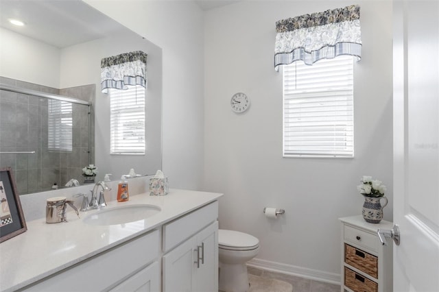 full bathroom featuring plenty of natural light, a stall shower, toilet, and vanity