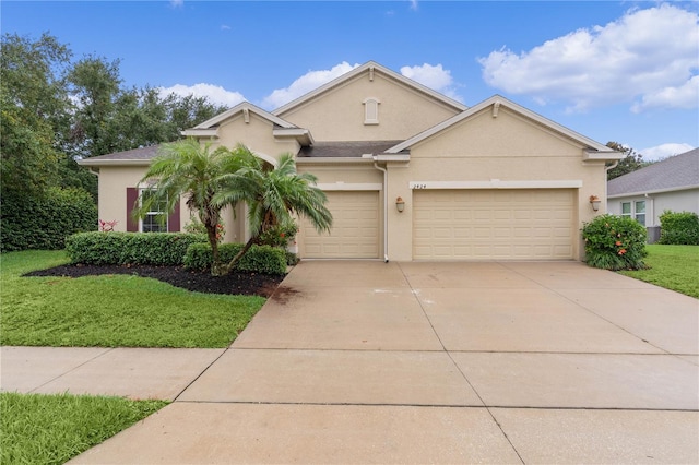 2424 Plumadore Dr, Grand Island, FL 32735 - view of front of property featuring stucco siding, driveway, an attached garage, and a front lawn