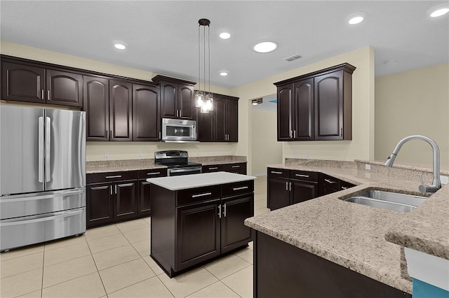 2424 Plumadore Dr, Grand Island, FL 32735 - kitchen featuring appliances with stainless steel finishes, a sink, light tile patterned floors, pendant lighting, and a kitchen island