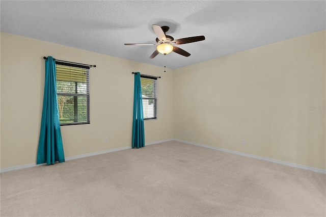 2424 Plumadore Dr, Grand Island, FL 32735 - empty room featuring a ceiling fan, light colored carpet, a textured ceiling, and baseboards