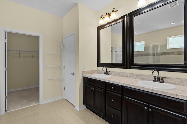 2424 Plumadore Dr, Grand Island, FL 32735 - bathroom featuring double vanity, a spacious closet, baseboards, a walk in shower, and tile patterned flooring