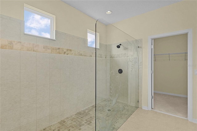 2424 Plumadore Dr, Grand Island, FL 32735 - bathroom with a walk in shower, tile patterned floors, a walk in closet, baseboards, and recessed lighting