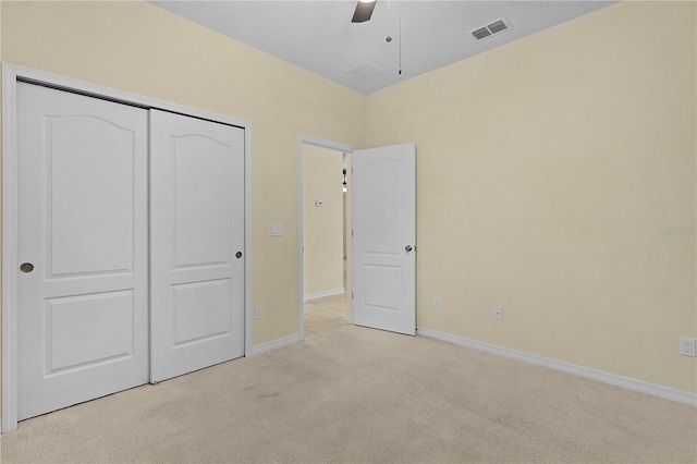 2424 Plumadore Dr, Grand Island, FL 32735 - unfurnished bedroom with light carpet, baseboards, a closet, and ceiling fan