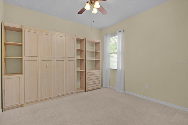 2424 Plumadore Dr, Grand Island, FL 32735 - unfurnished bedroom featuring light carpet, baseboards, and ceiling fan