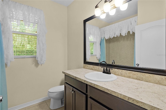 2424 Plumadore Dr, Grand Island, FL 32735 - bathroom featuring tile patterned flooring, toilet, vanity, and baseboards