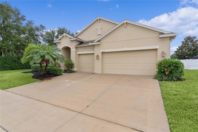 2424 Plumadore Dr, Grand Island, FL 32735 - view of front of home featuring stucco siding, an attached garage, and concrete driveway