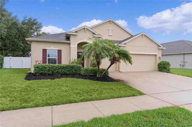 2424 Plumadore Dr, Grand Island, FL 32735 - view of front facade with an attached garage, stucco siding, driveway, and a gate