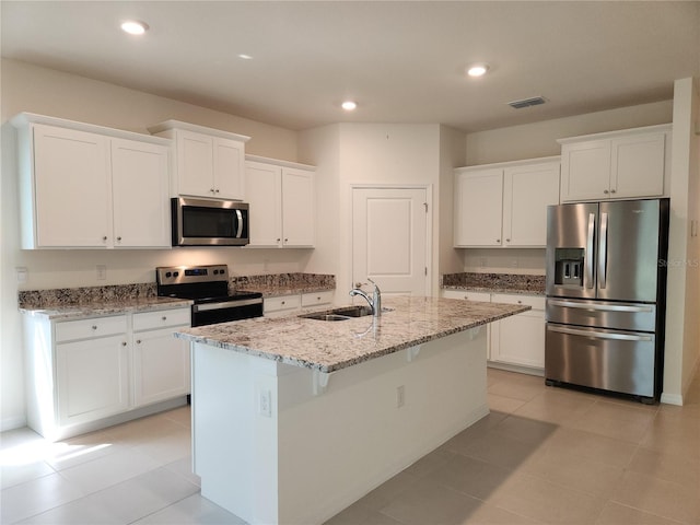 6203 SW 93rd Loop, Ocala, FL 34476 - kitchen featuring appliances with stainless steel finishes, a sink, white cabinetry, light stone countertops, and recessed lighting
