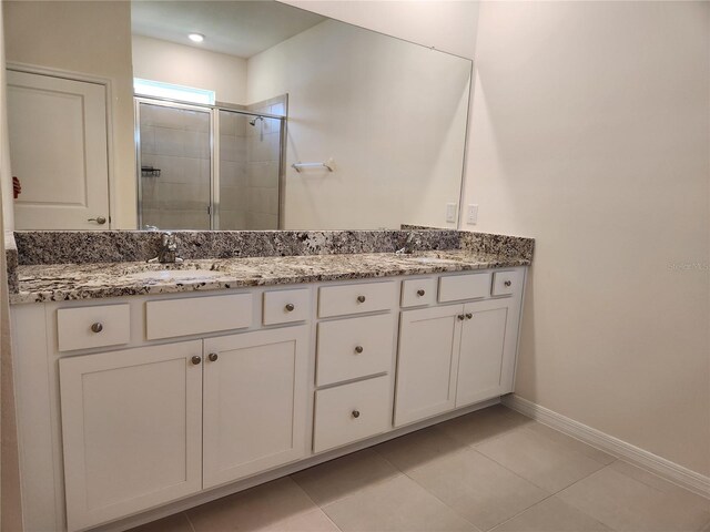 6203 SW 93rd Loop, Ocala, FL 34476 - bathroom with a shower stall, baseboards, double vanity, and tile patterned floors
