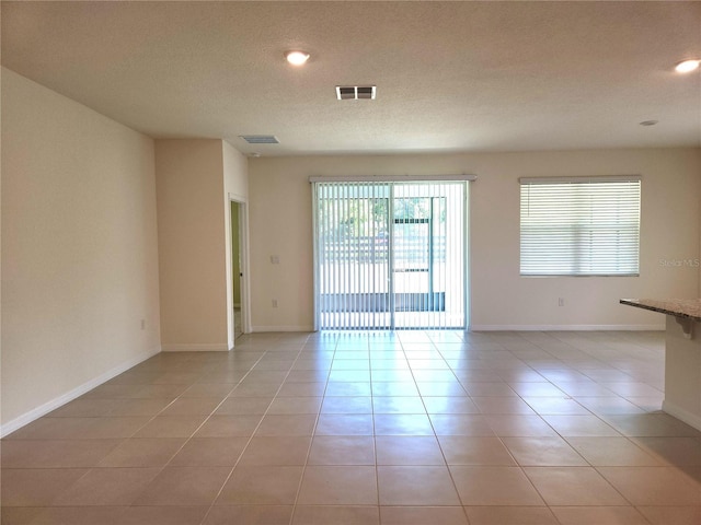 6203 SW 93rd Loop, Ocala, FL 34476 - unfurnished room featuring light tile patterned floors, a textured ceiling, baseboards, and recessed lighting