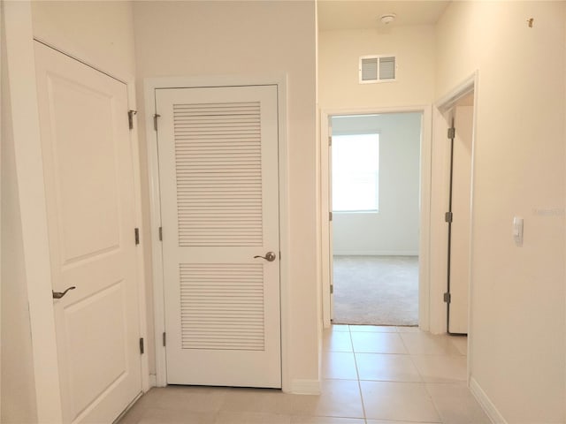6203 SW 93rd Loop, Ocala, FL 34476 - corridor with baseboards, light tile patterned floors, and light carpet