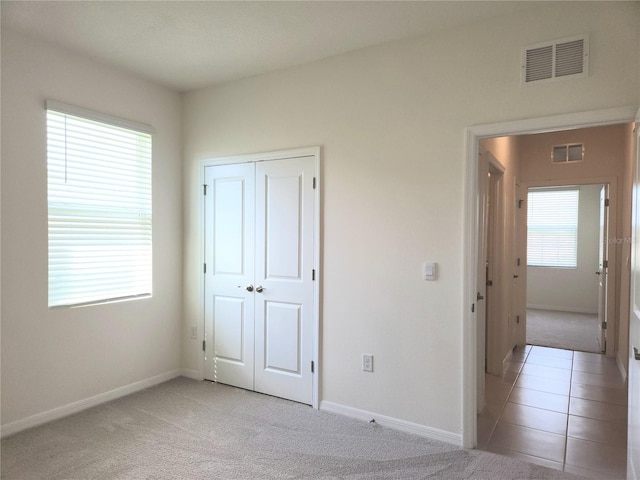 6203 SW 93rd Loop, Ocala, FL 34476 - unfurnished bedroom featuring light colored carpet, baseboards, and a closet