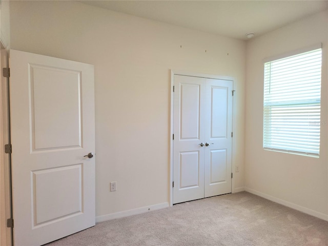 6203 SW 93rd Loop, Ocala, FL 34476 - unfurnished bedroom with light carpet, multiple windows, and baseboards