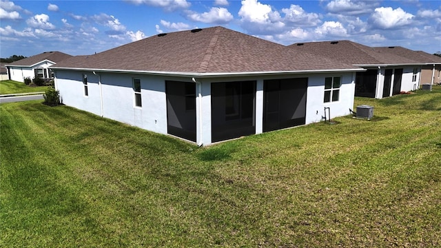 6203 SW 93rd Loop, Ocala, FL 34476 - rear view of house featuring a lawn, roof with shingles, a sunroom, and stucco siding