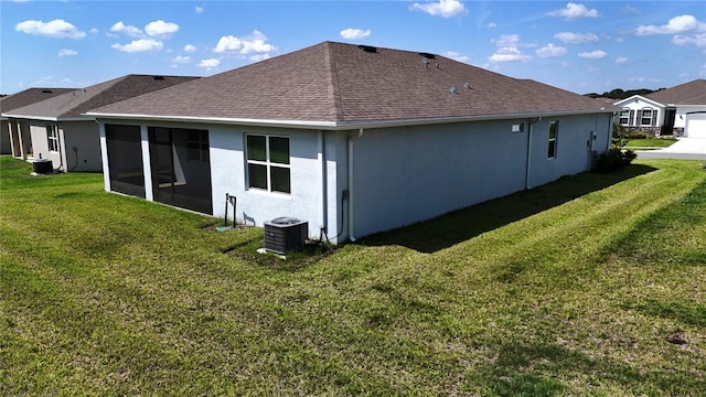 6203 SW 93rd Loop, Ocala, FL 34476 - back of house with central air condition unit, a lawn, stucco siding, and roof with shingles