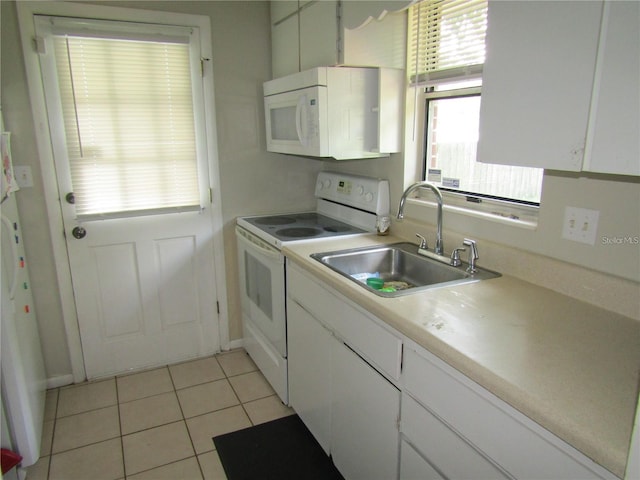 2501 Sheridan Rd, Mount Dora, FL 32757 - kitchen featuring white appliances, a sink, white cabinetry, light tile patterned floors, and light countertops