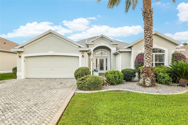 1521 Southport St, The Villages, FL 32162 - view of front of house with stucco siding, decorative driveway, a garage, and a front yard