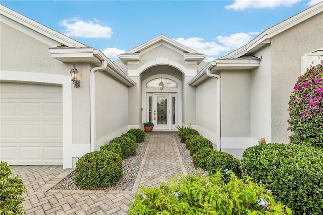 1521 Southport St, The Villages, FL 32162 - property entrance with a garage and stucco siding