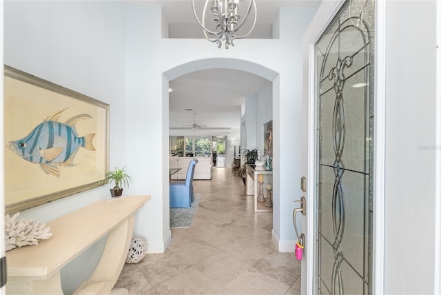 1521 Southport St, The Villages, FL 32162 - entryway with arched walkways, ceiling fan, a chandelier, and baseboards