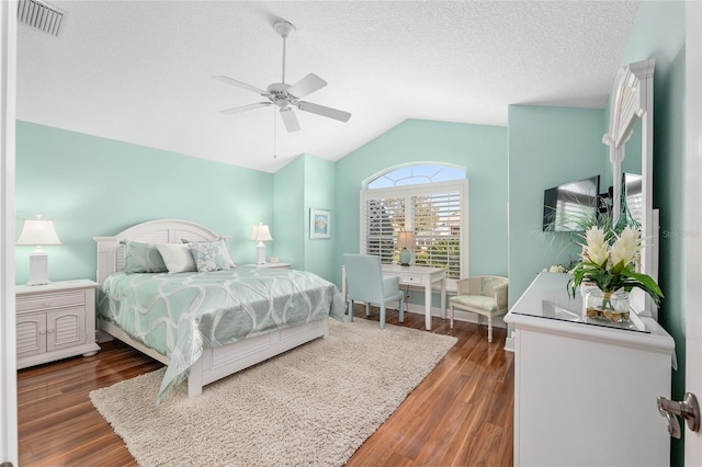 1521 Southport St, The Villages, FL 32162 - bedroom with vaulted ceiling, wood finished floors, ceiling fan, and a textured ceiling